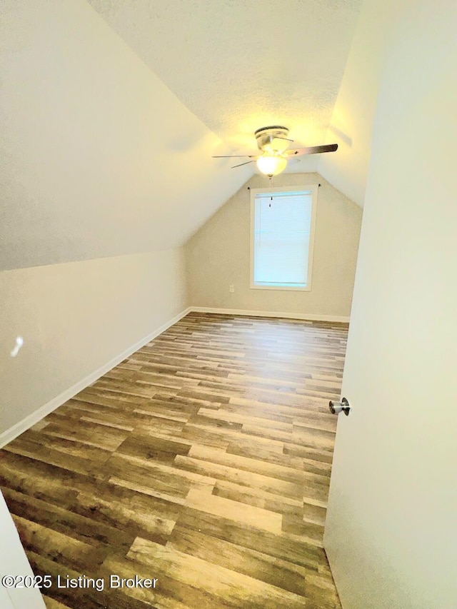 bonus room featuring wood-type flooring, vaulted ceiling, and ceiling fan