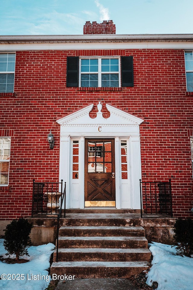 view of snow covered property entrance