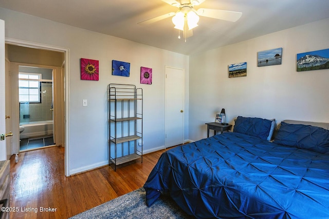 bedroom with dark hardwood / wood-style floors and ceiling fan