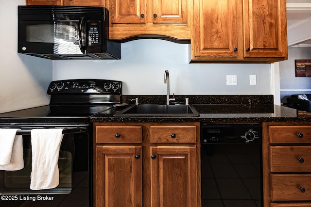 kitchen featuring dark stone countertops, tile patterned flooring, sink, and black appliances