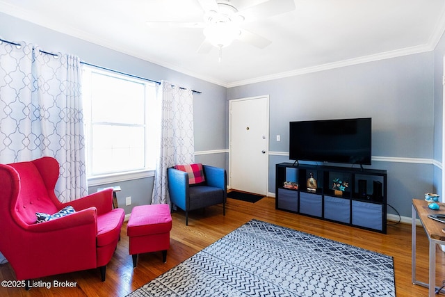 living area with crown molding, hardwood / wood-style flooring, and ceiling fan