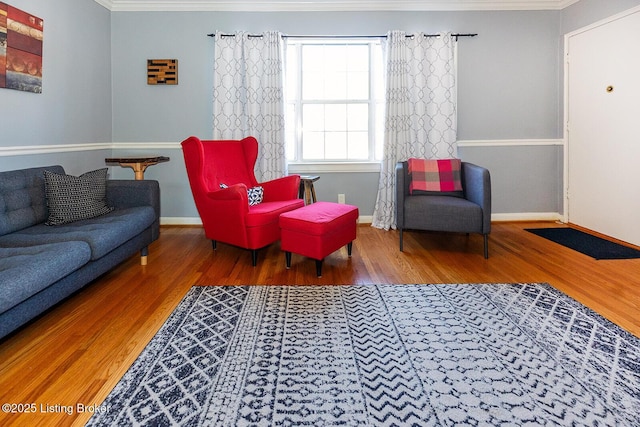 living room with ornamental molding and hardwood / wood-style floors