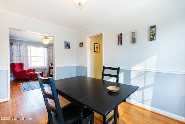 dining area with crown molding, hardwood / wood-style flooring, and ceiling fan