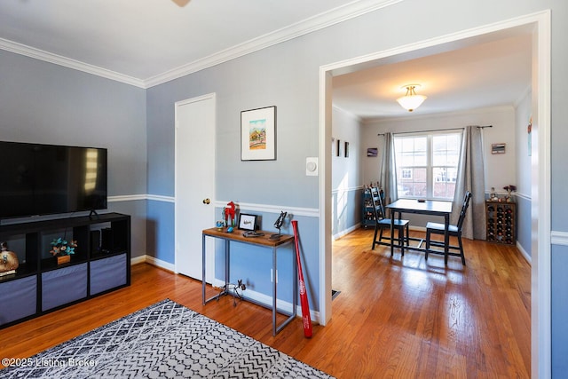 living room with crown molding and wood-type flooring