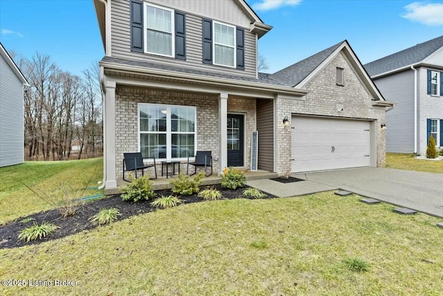 view of property with a garage, a front yard, and covered porch