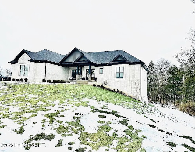 view of front of house featuring covered porch and a lawn