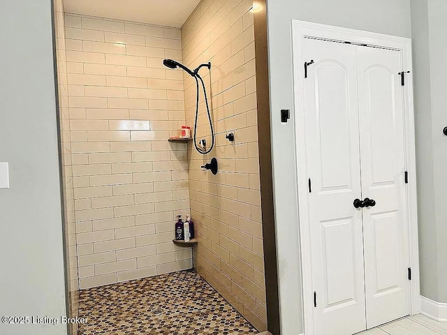 bathroom with tiled shower