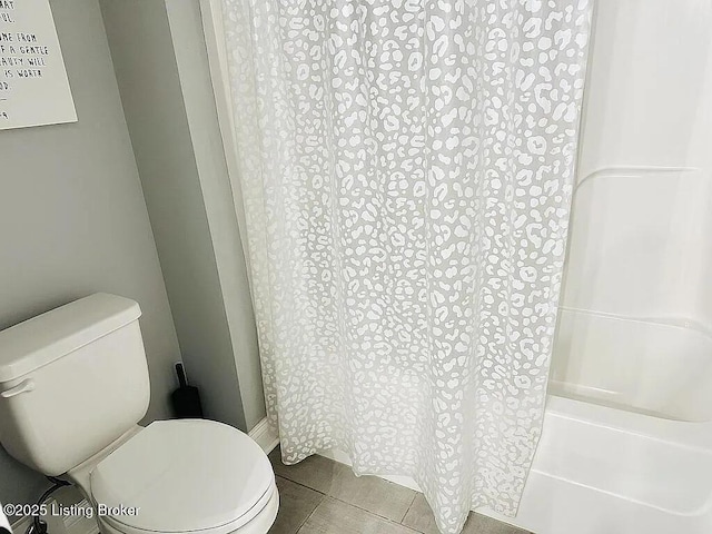 bathroom with tile patterned floors and toilet