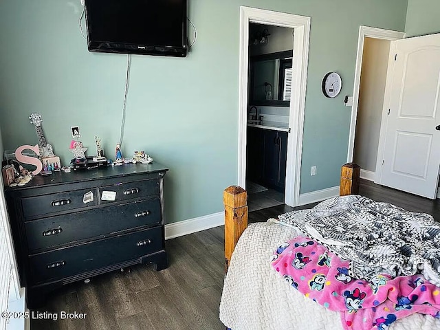 bedroom featuring dark hardwood / wood-style flooring and ensuite bathroom