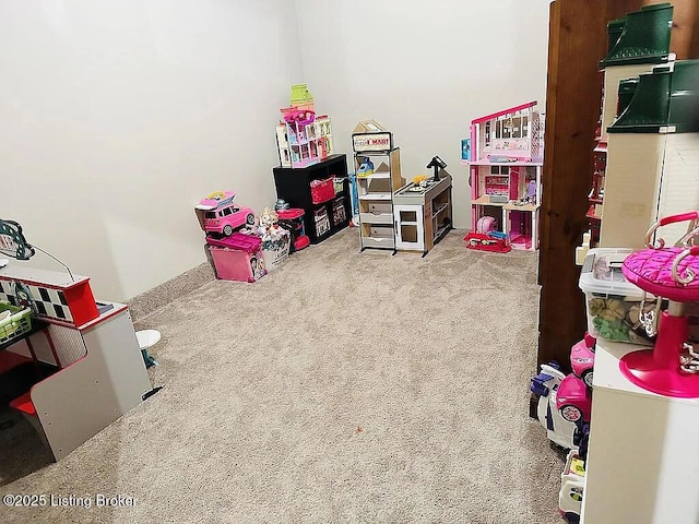 recreation room with carpet flooring