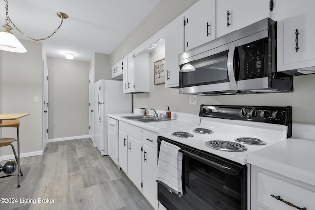 kitchen featuring electric stove, sink, white dishwasher, white cabinets, and decorative light fixtures