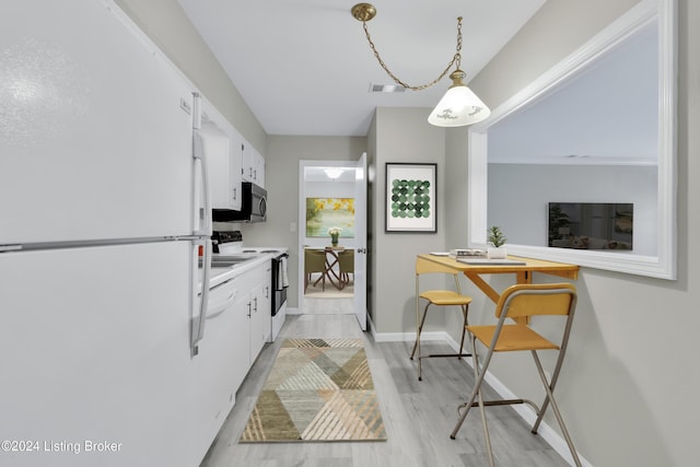 kitchen featuring white cabinetry, hanging light fixtures, white appliances, and light wood-type flooring