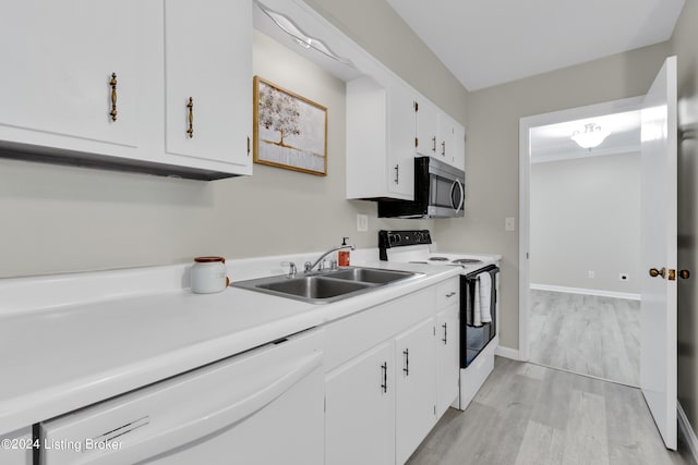 kitchen featuring white cabinetry, white appliances, sink, and light wood-type flooring