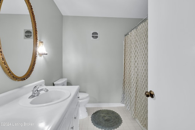 bathroom featuring vanity, toilet, and tile patterned flooring