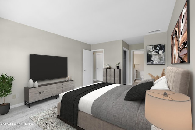 bedroom with light colored carpet and ensuite bathroom