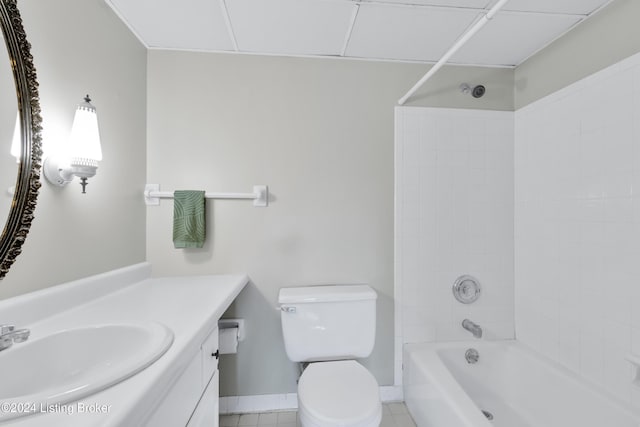 full bathroom featuring tiled shower / bath, vanity, toilet, and tile patterned flooring