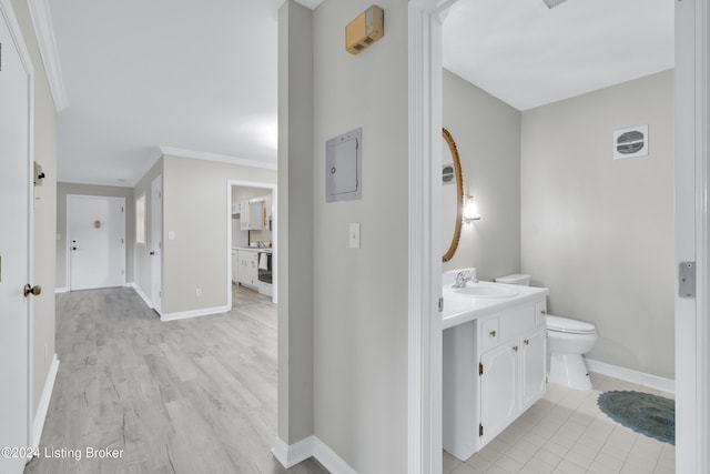 bathroom featuring crown molding, vanity, toilet, and wood-type flooring