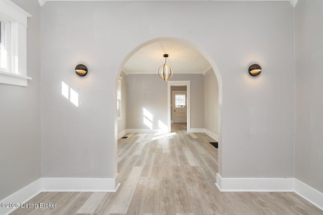 interior space featuring crown molding and light wood-type flooring