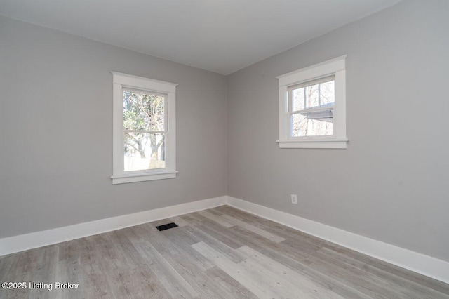 unfurnished room with light wood-type flooring