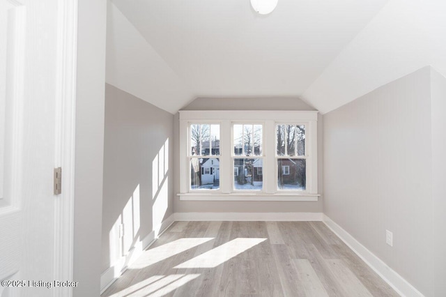 bonus room featuring vaulted ceiling and light wood-type flooring