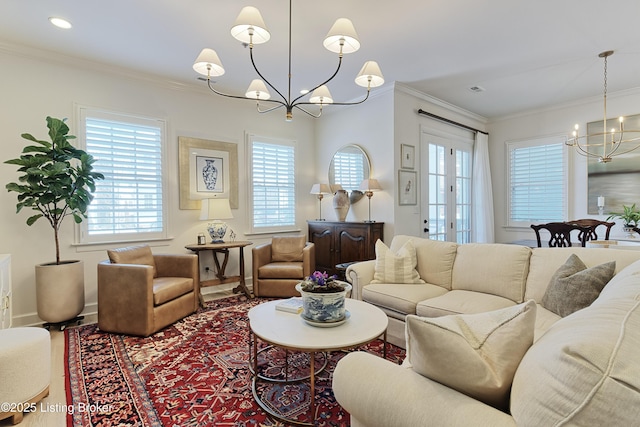 living room with an inviting chandelier and ornamental molding