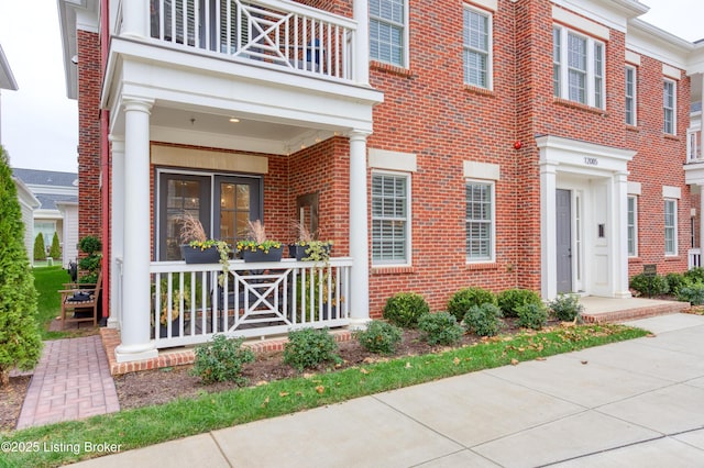 property entrance with a balcony and a porch