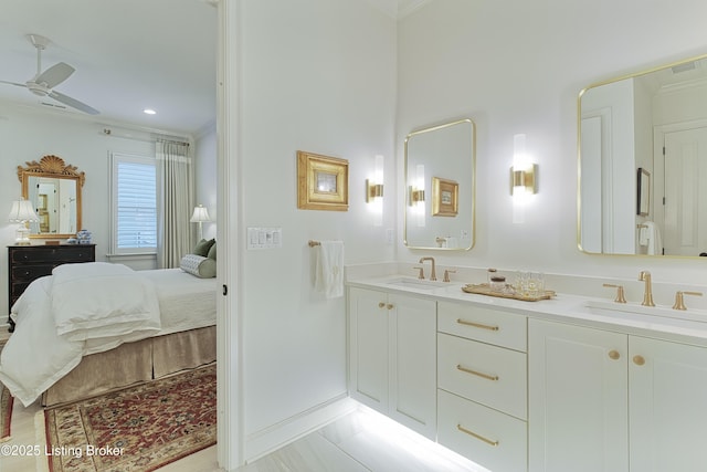 bathroom featuring ceiling fan, ornamental molding, and vanity