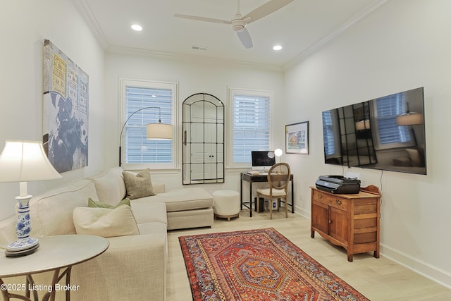 living room with ornamental molding, ceiling fan, and light hardwood / wood-style floors