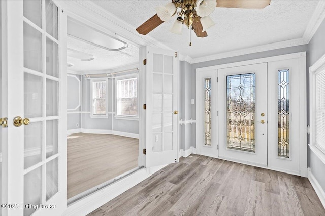 unfurnished sunroom featuring french doors and ceiling fan