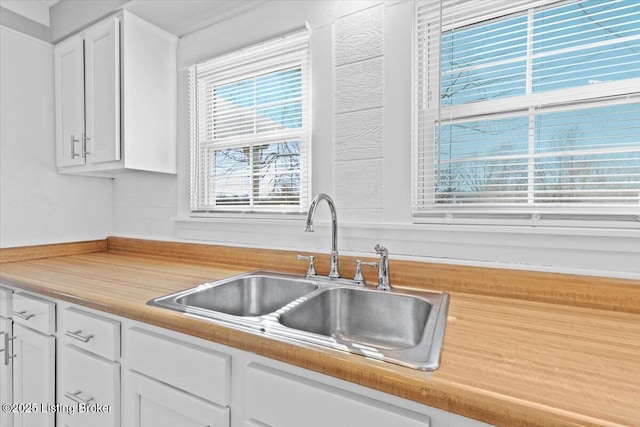 kitchen featuring sink and white cabinets