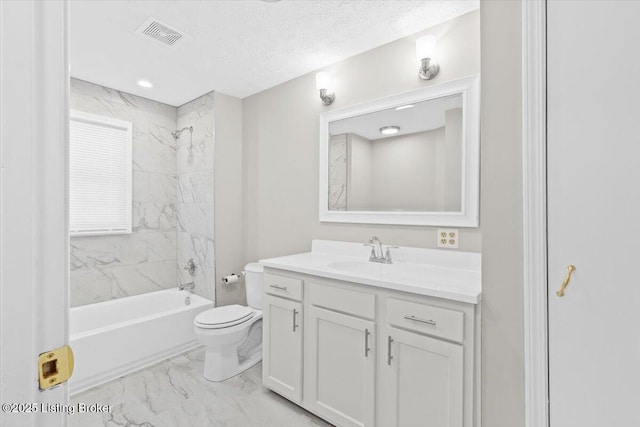 full bathroom featuring vanity, a textured ceiling, toilet, and tiled shower / bath