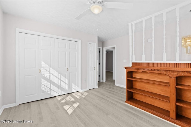 empty room with ceiling fan and light wood-type flooring