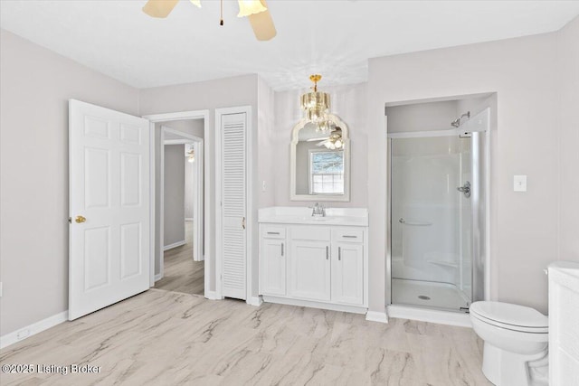 bathroom featuring an enclosed shower, vanity, toilet, and ceiling fan