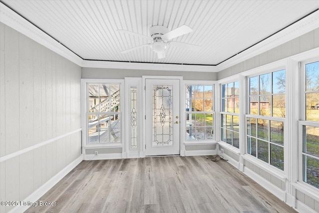 unfurnished sunroom with ceiling fan