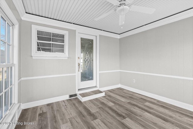 unfurnished room featuring hardwood / wood-style flooring, crown molding, and ceiling fan