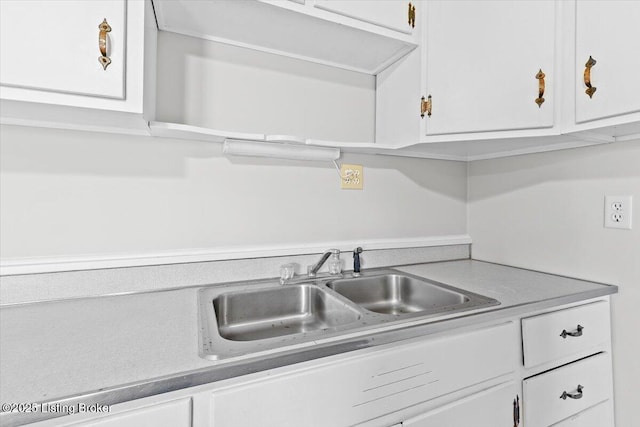 kitchen featuring sink and white cabinets