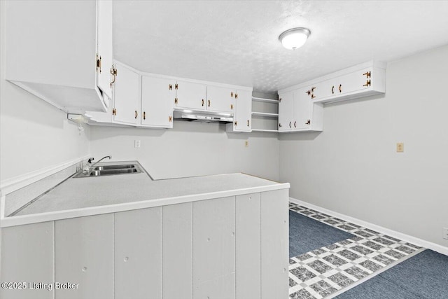 clothes washing area featuring sink and a textured ceiling