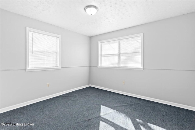 carpeted spare room featuring a textured ceiling