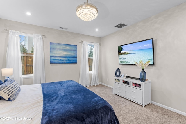 carpeted bedroom featuring multiple windows