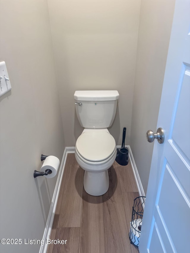 bathroom featuring wood-type flooring and toilet