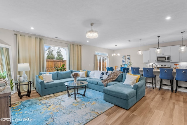 living room with sink and light hardwood / wood-style floors