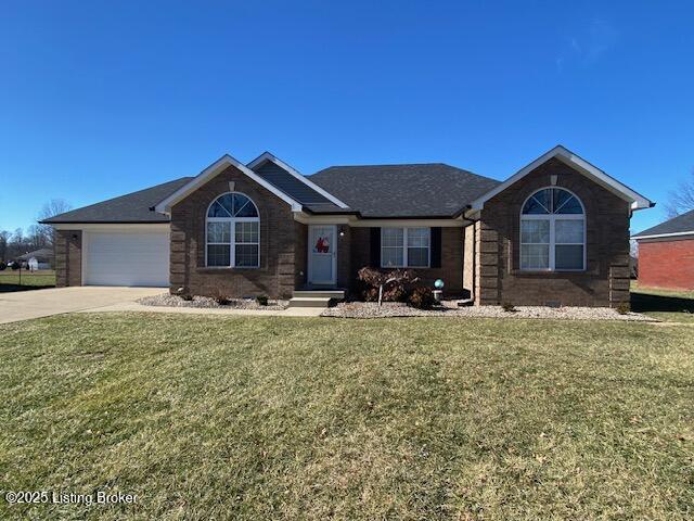 single story home with a garage and a front yard