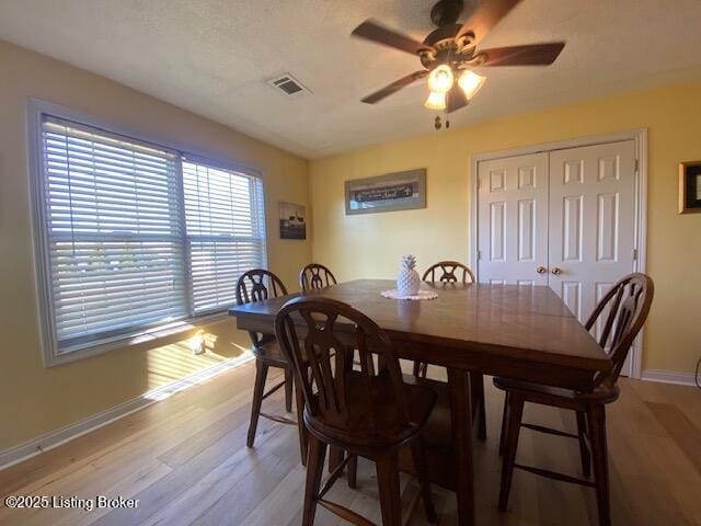 dining area featuring ceiling fan and light hardwood / wood-style flooring