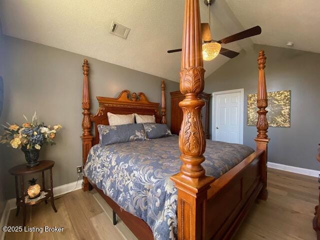 bedroom featuring ceiling fan, wood-type flooring, and vaulted ceiling