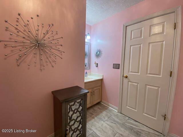 bathroom with vanity and a textured ceiling