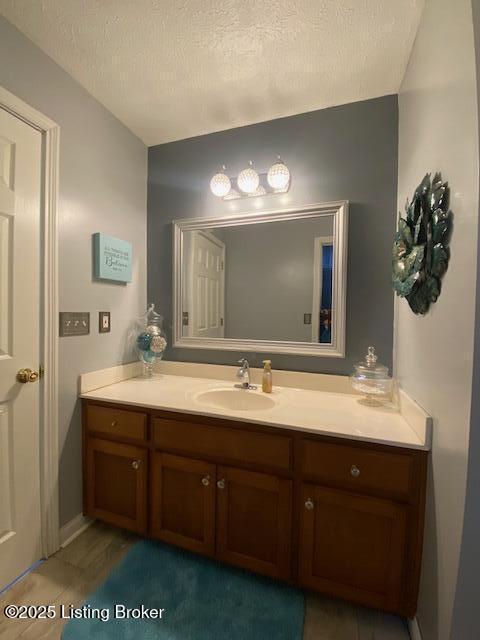 bathroom with vanity and a textured ceiling