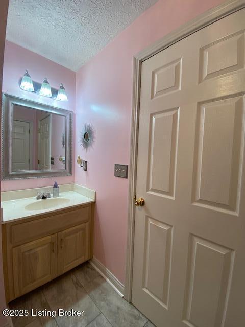 bathroom with vanity and a textured ceiling