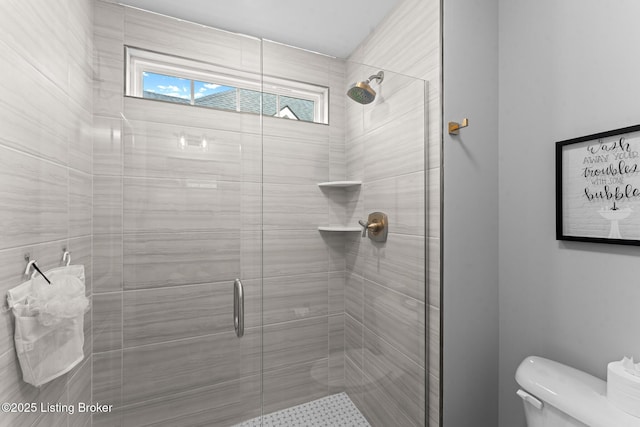 bathroom with an enclosed shower and toilet