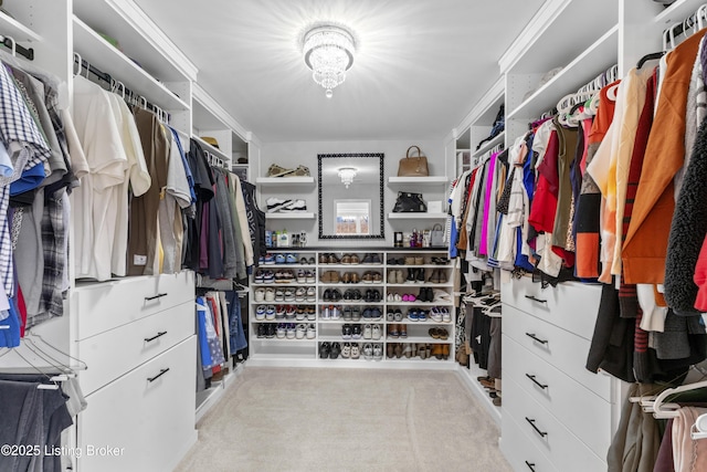 walk in closet featuring light colored carpet