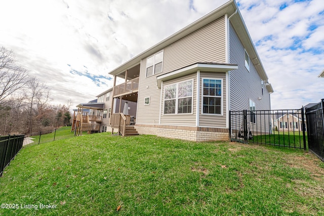 rear view of property with a wooden deck, a balcony, and a yard